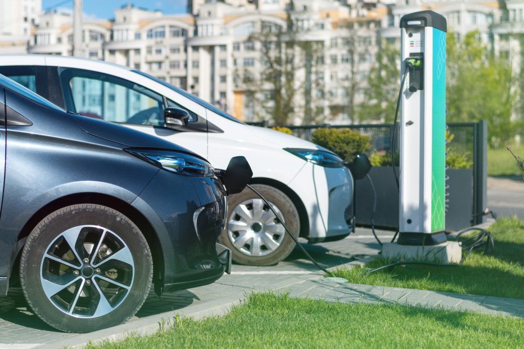 Two electric vehicles charging at a station